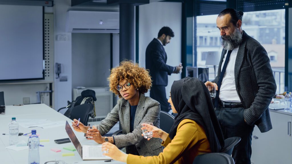 A group of employees debating in a conference room. 