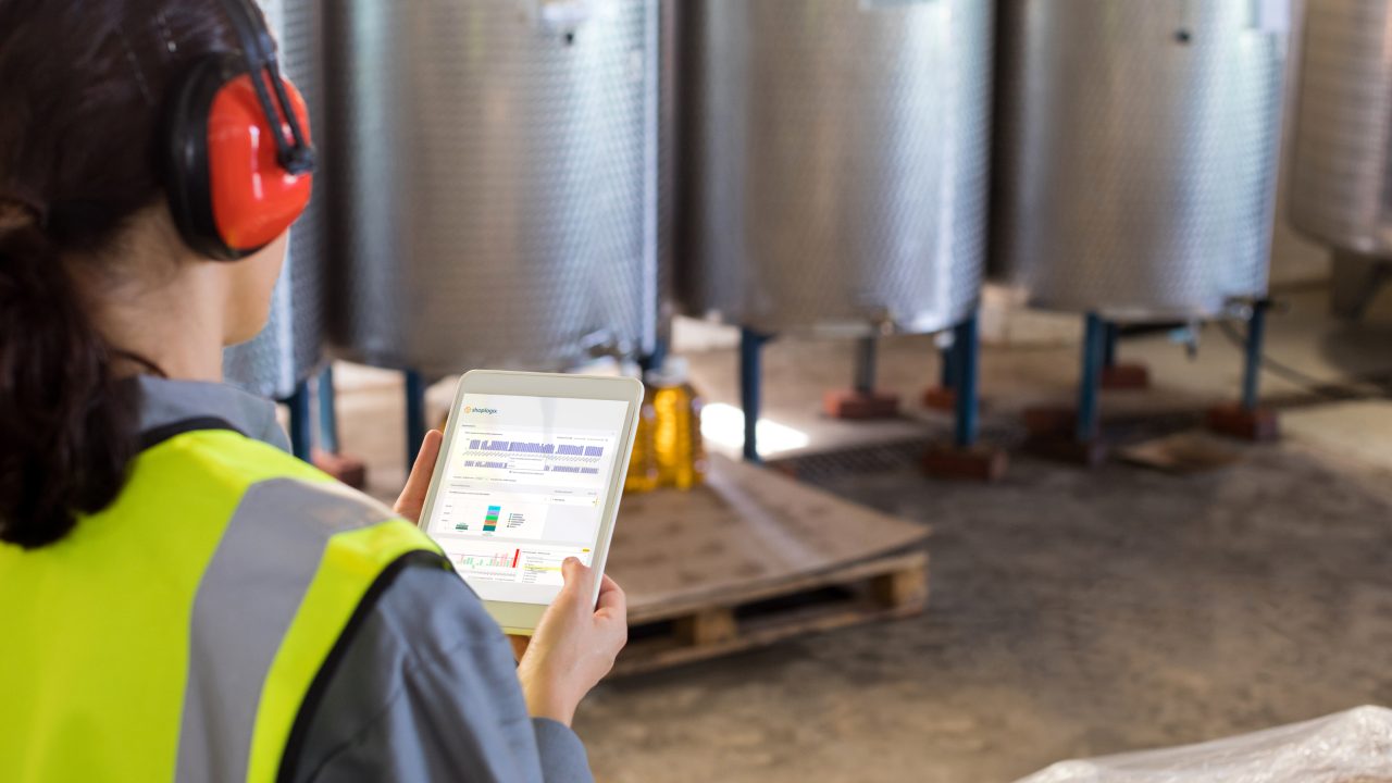 Portrait of female technician with a tablet displaying statistics from Shoplogix