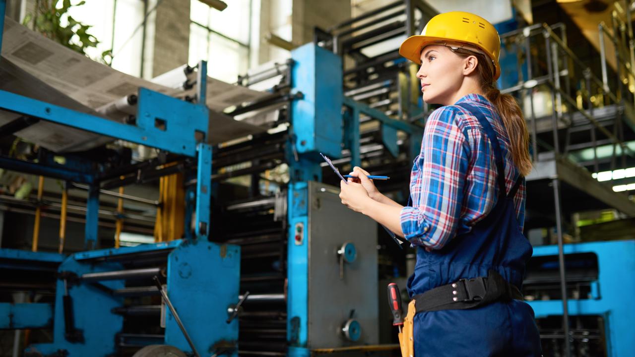 Female factory worker supervising quality in workshop