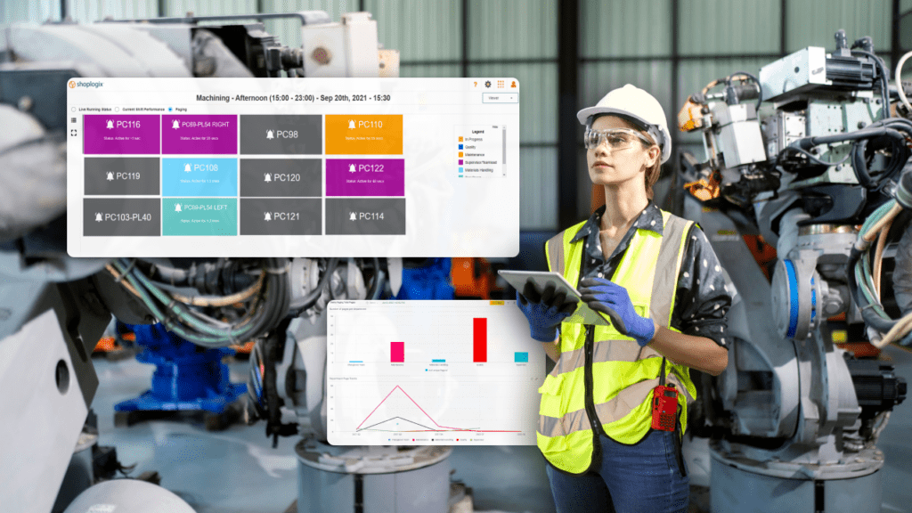 female engineer standing in between robotic arms while holding a tablet