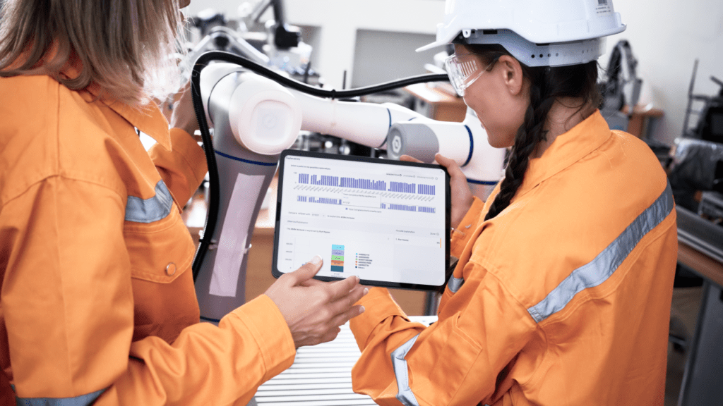 Two female shop floor engineers reading data on a tablet